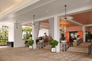 a lobby of a resort with chairs and tables at PGA National Resort in Palm Beach Gardens