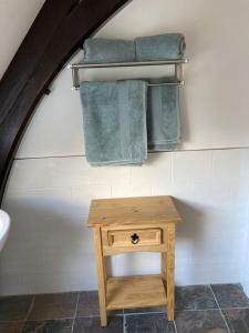 a bathroom with a wooden table and towels at Fantastic Cottage in Loch Lomond National Park in Alexandria +9 photos