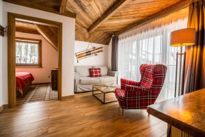 a living room with a couch and a chair at Gościniec Kuźnice in Zakopane