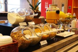 a display of food in glass bowls on a counter at Ibis Guaxupe in Guaxupé