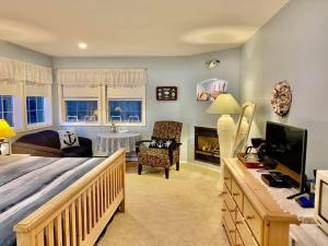 a bedroom with a bed and a living room at Seafarer Bed & Breakfast in Tofino