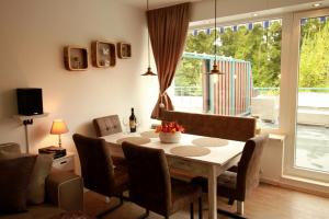 a living room with a dining room table with chairs at Th 625 Panoramic Hohegeiß in Braunlage