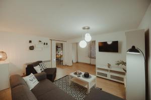 a living room with a couch and a table at Kućica in Đakovo