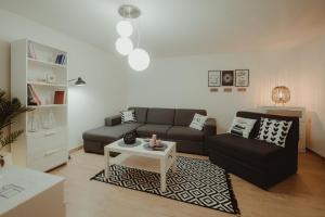 a living room with a couch and a table at Kućica in Đakovo