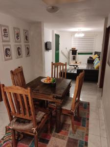a dining room table with chairs and a bowl of fruit on it at Cosy Appartement in Majdal Shams