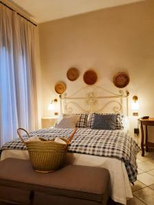 a bedroom with a bed with a basket on it at Boutique Hotel Fox's Inn in San Giustino Valdarno