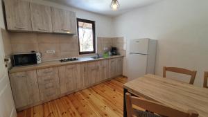 a kitchen with a table and a refrigerator at Bran Hill in Bran