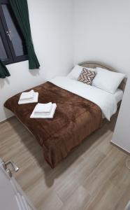 a bedroom with a bed with a brown blanket at Cozy Home Kolasin in Kolašin