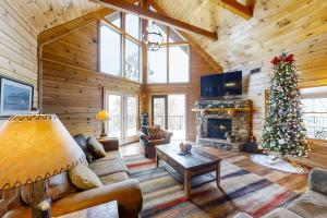 a living room with a christmas tree in a log cabin at Inspiration Point in Dupont Springs