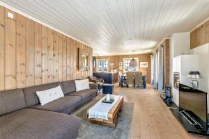 a living room with a couch and a table at Gaustablikk hytta ski-in ski-out in Gaustablikk