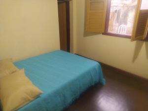En eller flere senge i et værelse på Oro Hospedaria