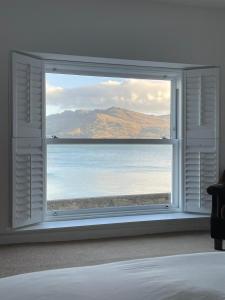 a bedroom window with a view of the ocean at 'A room with seaview' on Carlingford Lough in Warrenpoint