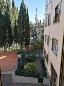 a view of a garden with trees and a building at Poggetto home in Florence
