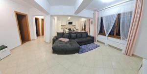 a large living room with a couch and a table at apartament BEST VIEW in Buşteni