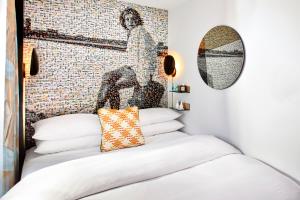 a bedroom with a bed with a mosaic wall at The Hotel Castro San Francisco in San Francisco