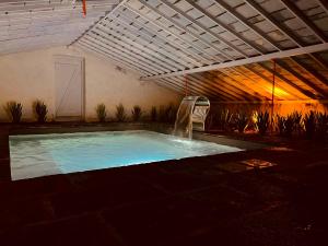 a swimming pool with a water slide in a building at Herdade do Ananás in Ponta Delgada