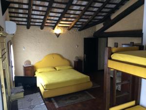1 Schlafzimmer mit 2 Betten und gelber Bettwäsche in der Unterkunft Il Podere Del Convento in Villorba