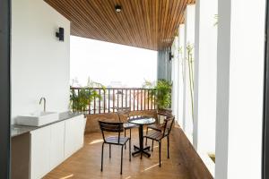 a kitchen with a table and chairs on a balcony at Sea Night Hotel in Phan Thiet