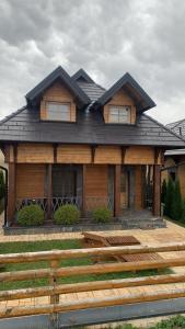 a wooden house with a black roof at Mountain Villa Zlatibor in Zlatibor
