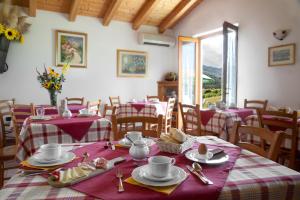 a dining room with red and white tables and chairs at Agritur La Cort in Arco