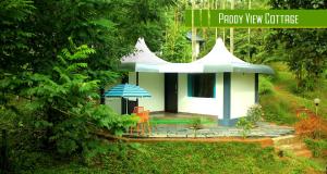 a small house with a blue and white roof at Vintage Garden Resort in Sultan Bathery