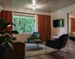 a living room with a couch and chairs and a window at Kyah in Blackheath