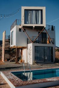 a house with a swimming pool in front of it at The Pangea Valle de Guadalupe in Valle de Guadalupe