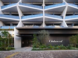 an exterior view of a building with the outmund sign at Oakwood Hotel & Apartments Azabu Tokyo in Tokyo