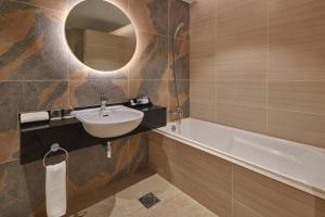a bathroom with a sink and a bath tub at Cititel Mid Valley in Kuala Lumpur