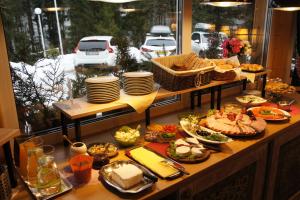 a buffet of food on a table with plates and dishes at Gronik in Szczyrk