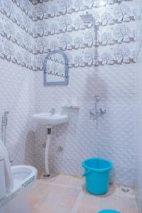 a bathroom with a sink and a toilet and a tub at Mehra Cottage in Almora