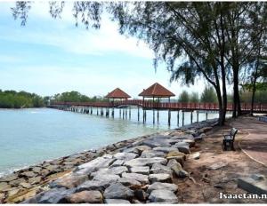a dock with a pier with a bench next to the water at Mulberi Homestay 4BR 3Bth(8-10 px) in Port Dickson