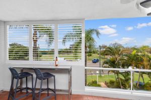 a living room with a view of the ocean at Sundeck Gardens in Maroochydore
