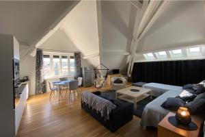 a living room with a couch and a table at Demeure Saint Louis Historic manor, air-conditioned, free private parking, City 700m, WIFI, view in Carcassonne +151 photos