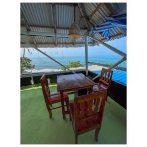 a table and chairs with a view of the ocean at Sand castle varkala in Varkala