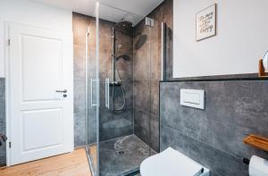 a bathroom with a shower stall and a toilet at Ferienhaus Heuliebe in Herbstein +30 photos