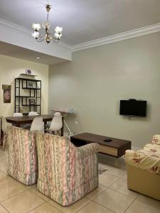 ein Wohnzimmer mit einem Sofa und einem Tisch in der Unterkunft Jarzmin Double Story Homestay @ Royal Lily in Tanah Rata