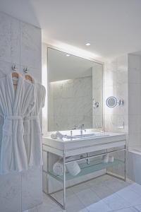 a bathroom with a sink and a large mirror at InterContinental Luanda Miramar, an IHG Hotel in Luanda
