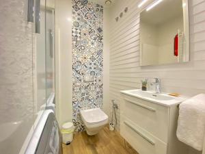 a bathroom with a toilet and a sink and a mirror at Castillo Bajo - Adults Only in Torrox Costa +2 photos