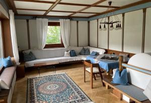 a living room with a couch and a table at Villa Maria Dolomites Vintage Home in Brunico