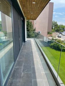 an empty balcony of a building with glass windows at Studio Cuzino 106 Pipera in Voluntari