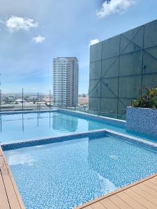 a large swimming pool on top of a building at Hola! Condotel @ Inspiria Davao in Davao City