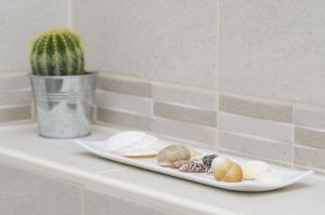 a plate of food on a counter next to a cactus at Apartment Rafaello in Dubrovnik