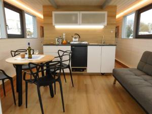 a kitchen and living room with a table and chairs at Hausbót na Vltavě in Hradišťko