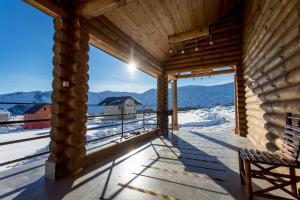 a log cabin with a view of the mountains at Snow Time Eco Chalet in Gudauri