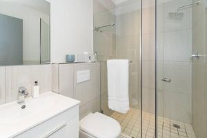 a bathroom with a shower and a toilet and a sink at 9 Church View - No LoadShedding - Homely Apartment in Cape Town