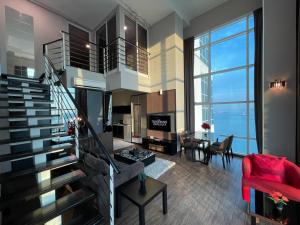 a living room with a staircase and a red couch at Maritime Seaview Hotel by SS Setia Resort in George Town