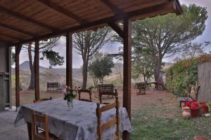 a table with a vase of flowers on top of it at Podere San Francesco in Volterra