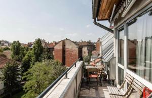 a balcony with a table and chairs on a building at Penthouse -By the Danube in Budapest