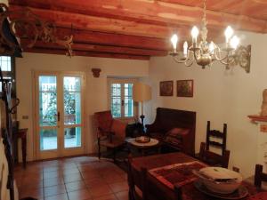 a living room with a table and a chandelier at Belgirate Casa Emilia in Belgirate